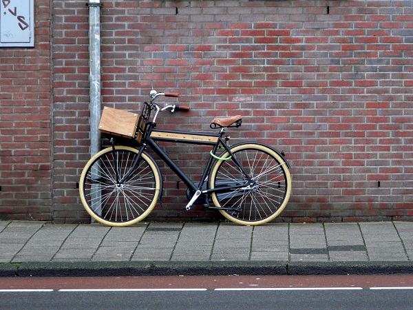 A bicycle against a brick wall.